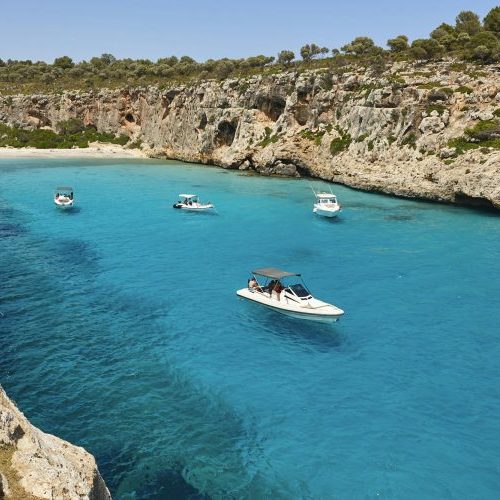Cala d'Or bay on Mallorca with boats in the turquoise water