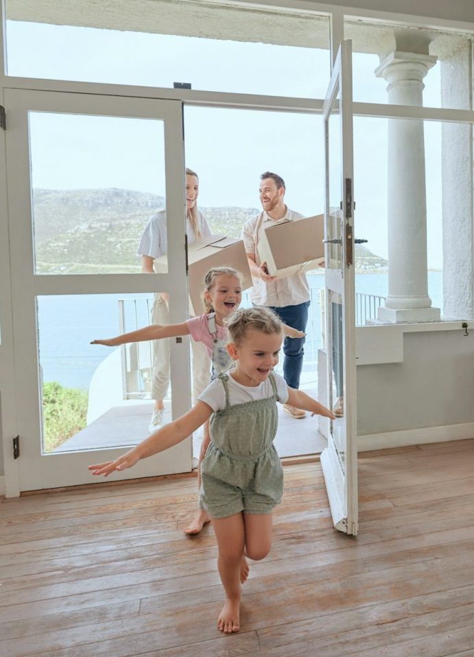 Building plot on the coast with newly built villa and family moving in