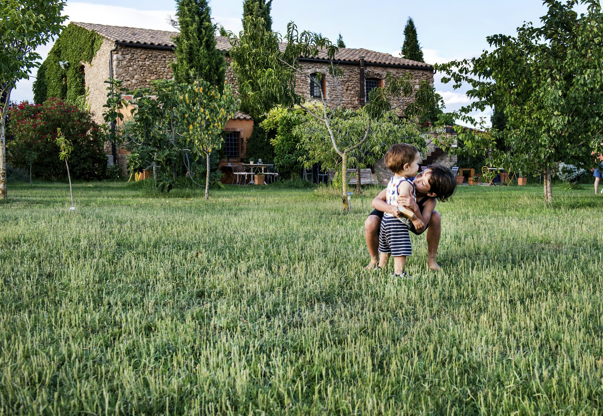 Children play in the garden of a traditional finca in Mallorca