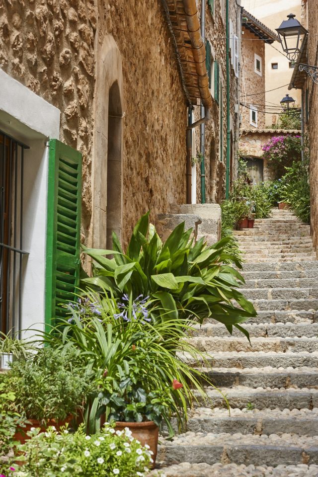 Traditional stone house façade decorated with plants in Deia on Mallorca