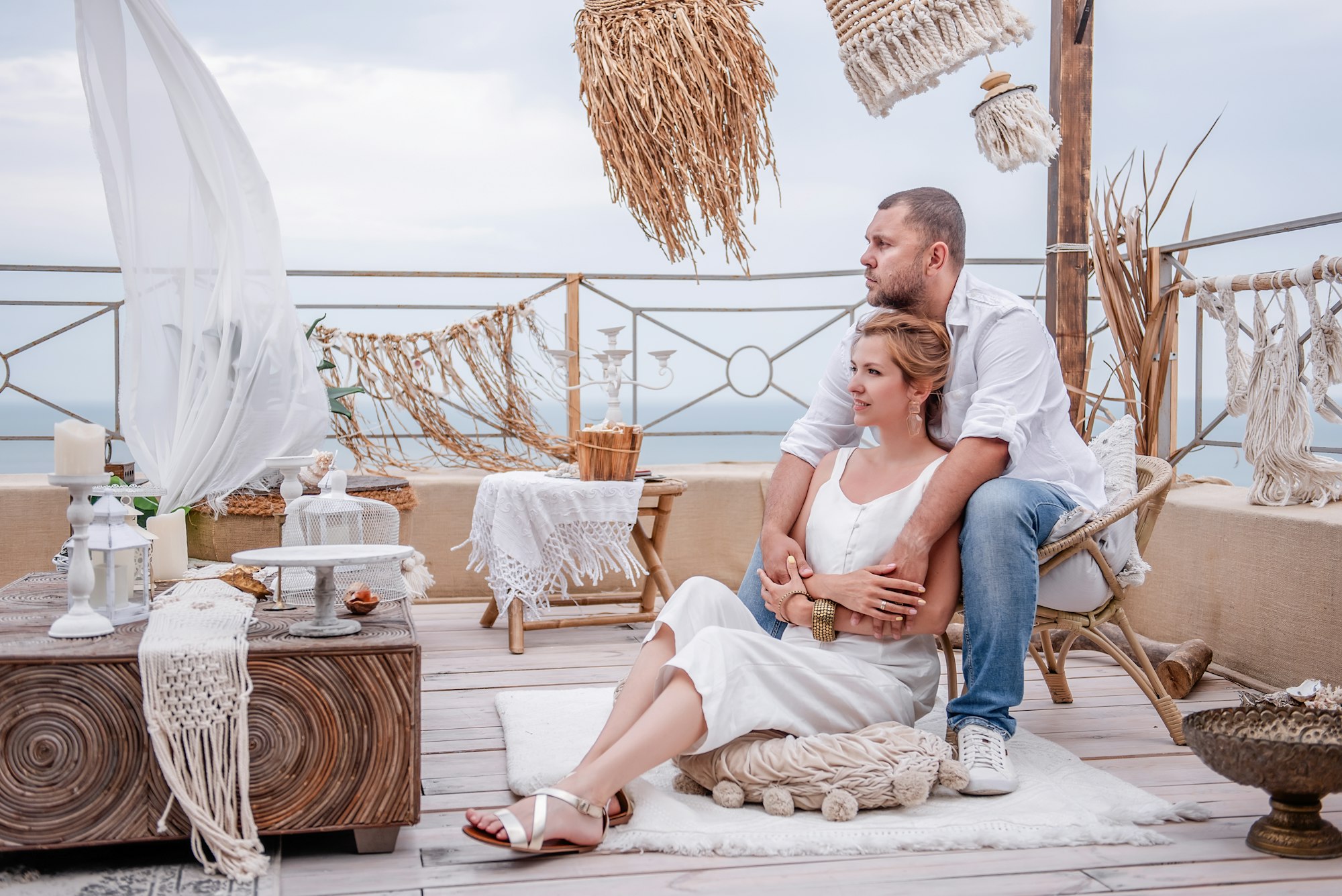 Young couple on the roof terrace of their villa with sea view in Mallorca