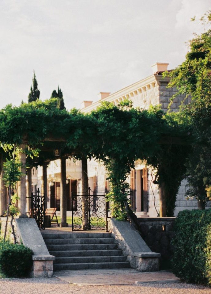 Stone staircase in front of the green terrace of a traditional luxury villa in Mallorca