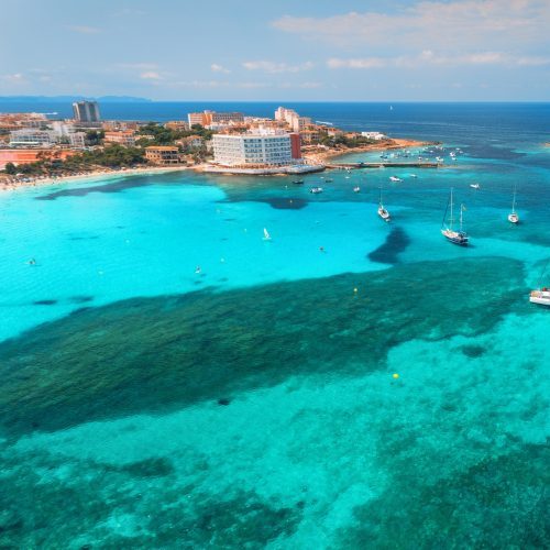 Port d'Alcúdia aerial view of boats and luxury yachts in the sea at sunset